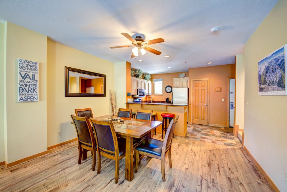 Dining room table is wood with tiles.  Perfect for dinner or game night!