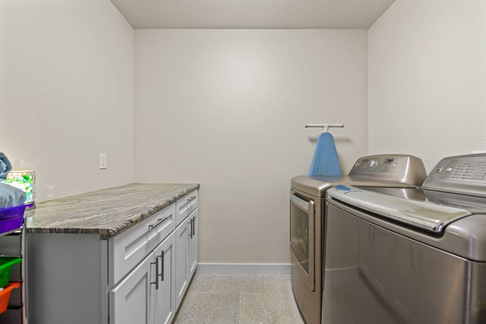 laundry room with ironing board in case you need it.