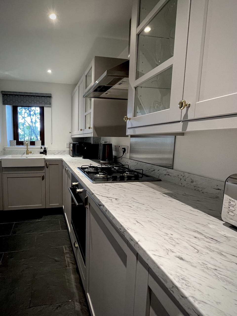 Fitted kitchen with oven, hob, dishwasher and washing machine.
