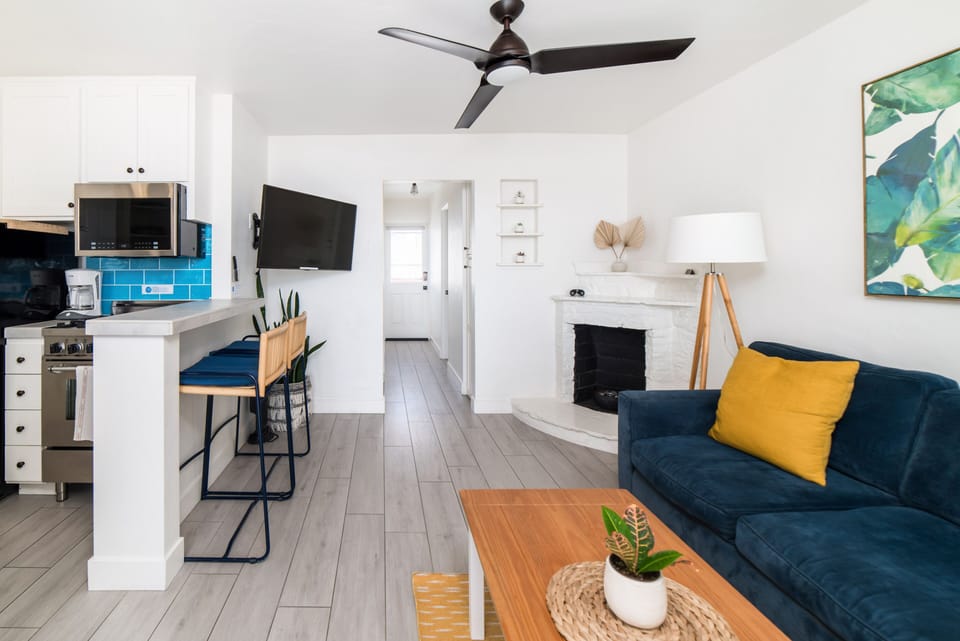 Ocean view living room with smart television. Netflix and HULU with Live TV accounts signed in for guest use. Room also features the original 1940s fireplace (gel fuel provided for guest use).