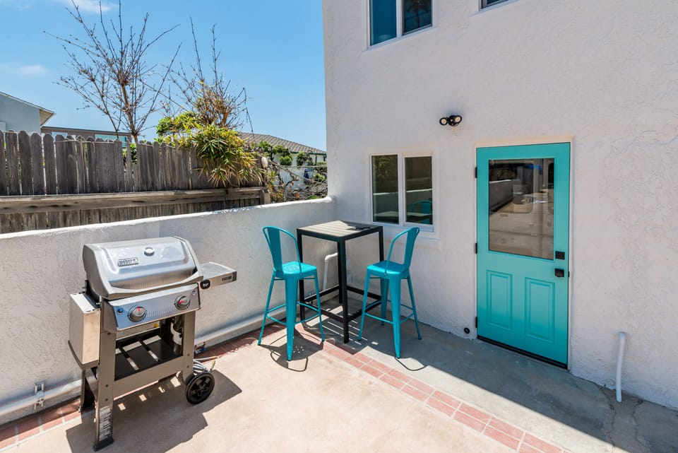 Common area space with grill (one of two located in complex) and laundry room