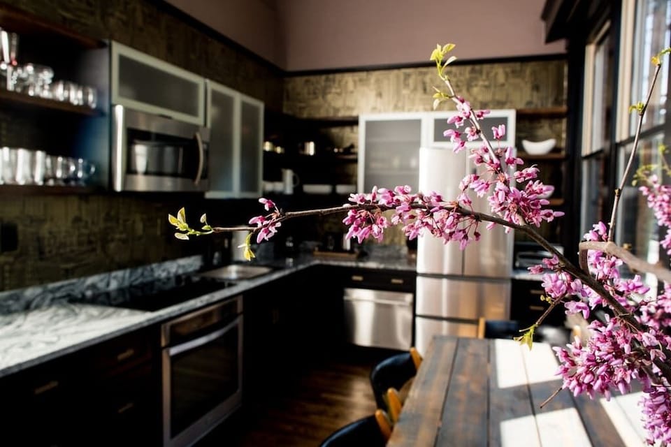 The kitchen's contemporary design complements the apartment's industrial aesthetic