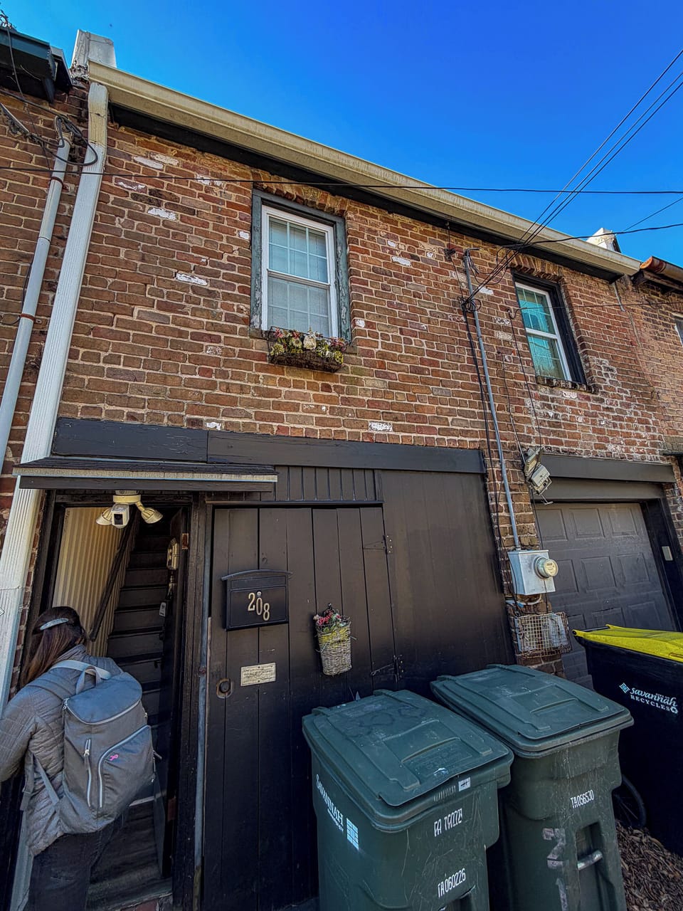 Charming brick townhouse exterior with private entry and urban character