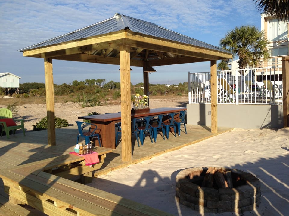 Covered Outdoor Table right next to the fun private beach oasis! 