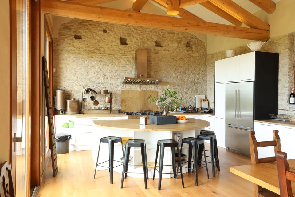 The island with bar seating, power outlets, and sink in the large open kitchen