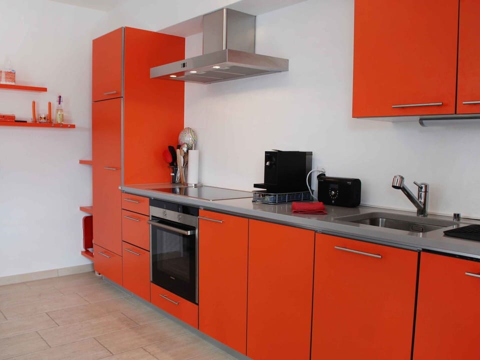 Countertop, Kitchen, Orange, Room, Cabinetry, Furniture, Property, Kitchen Stove, Interior Design, Material Property