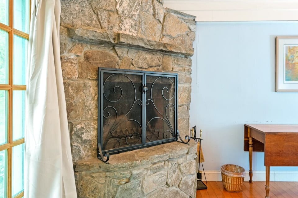 Bedroom sitting area with stone fireplace