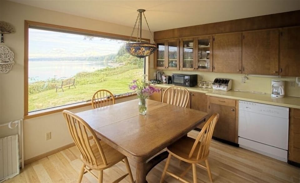 Dining room and kitchen water view, dishwasher, microwave, oak table