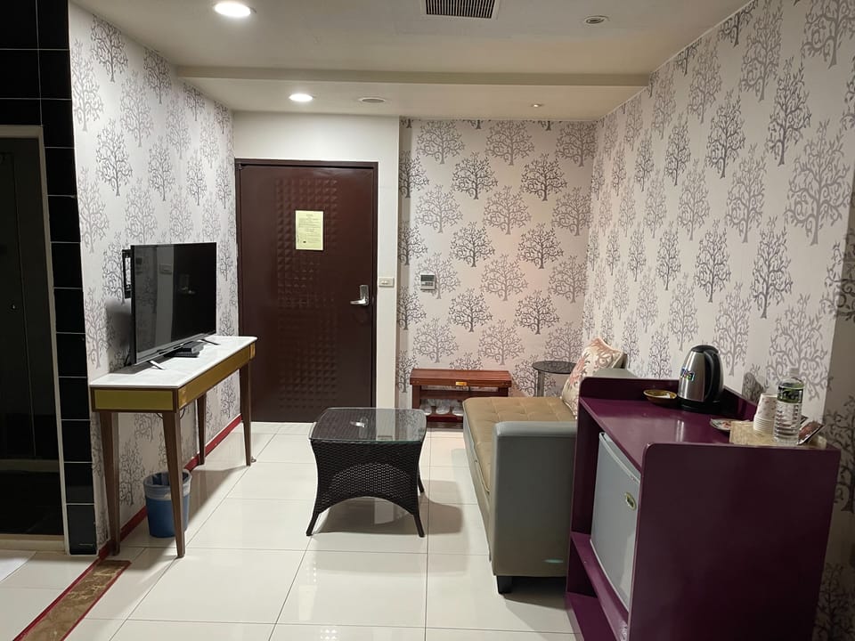 Basic Quadruple Room, 2 Queen Beds | Living area | LCD TV