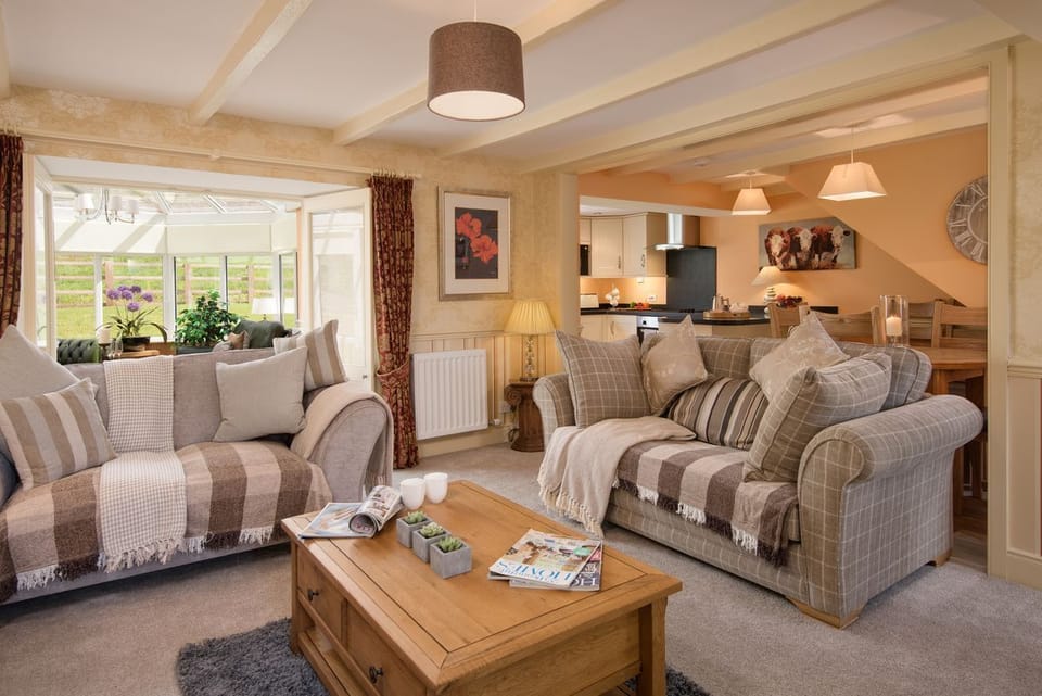 Dryburgh Stirling Two - open-plan living area with sitting room, dining area and kitchen with door leading to conservatory