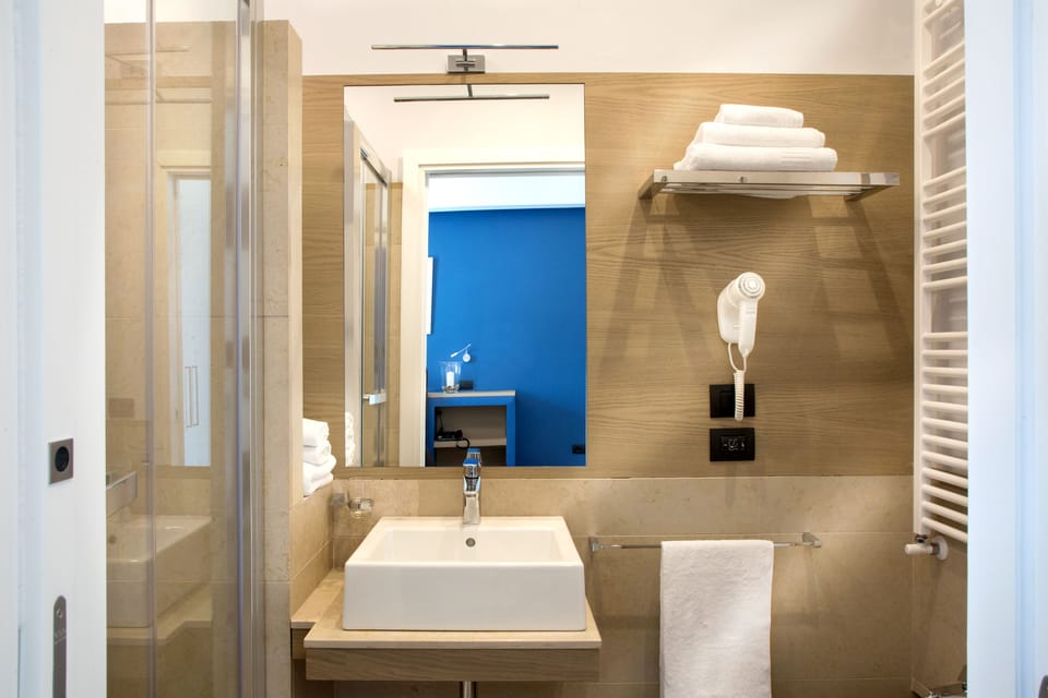 Deluxe Suite, 1 Queen Bed, City View | Bathroom | Shower, rainfall showerhead, designer toiletries, hair dryer