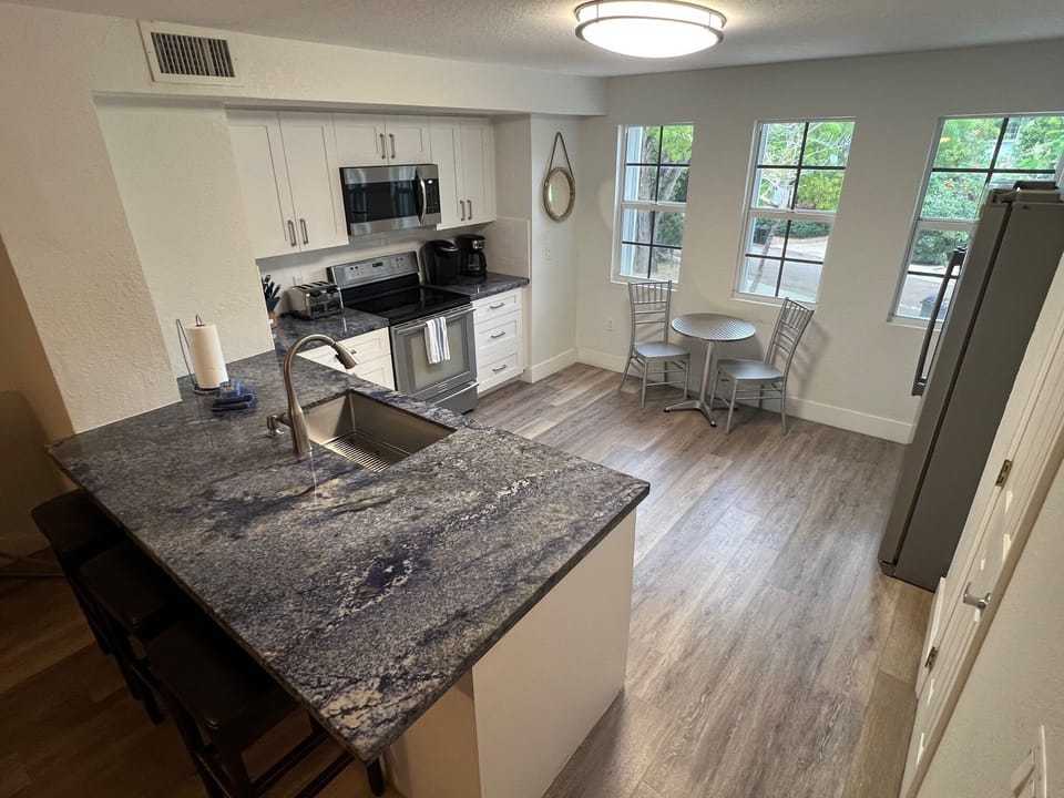 Modern Kitchen W/Exotic Blue Granite Countertops and Wood Plank Flooring