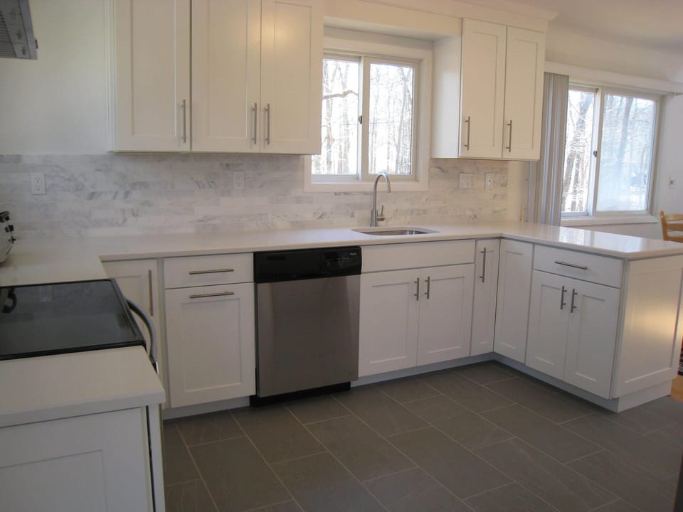 Modern kitchen with custom tile backsplash and stainless steel appliances
