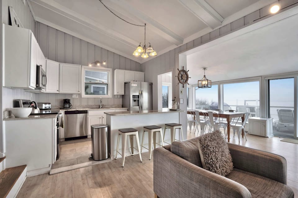 Kitchen adjacent to dining area with water views.
