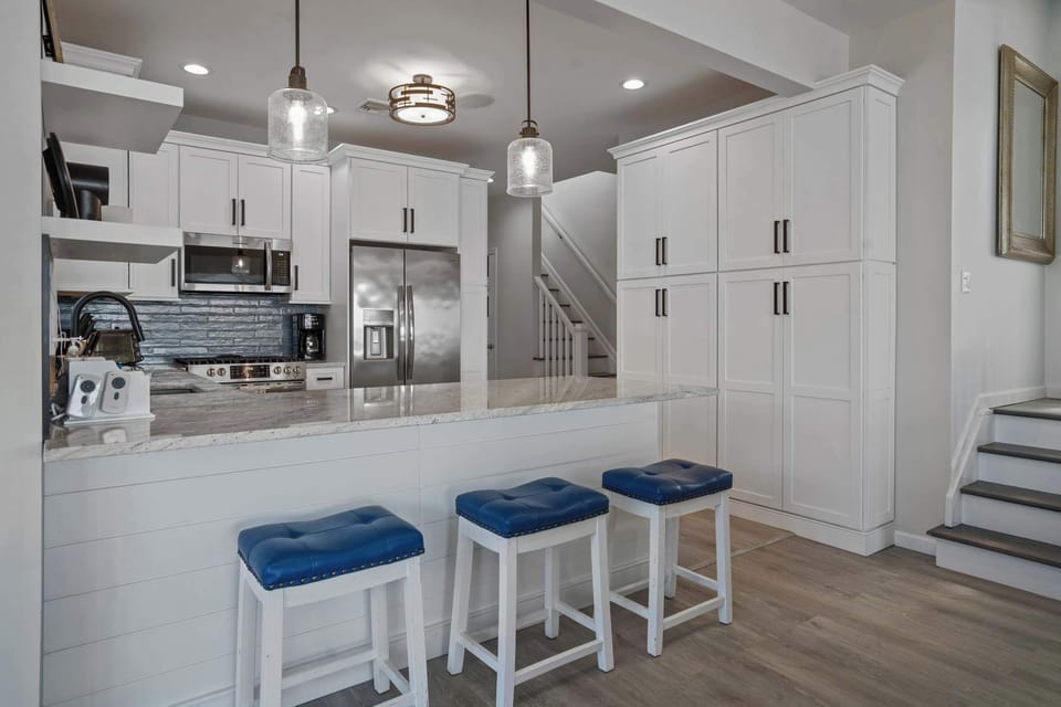Fully equipped kitchen and stairs going to the bedrooms