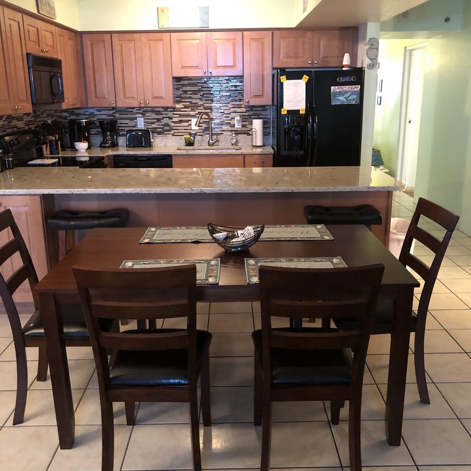 Kitchen and dining. Seating for 8 with two extra chairs in condo