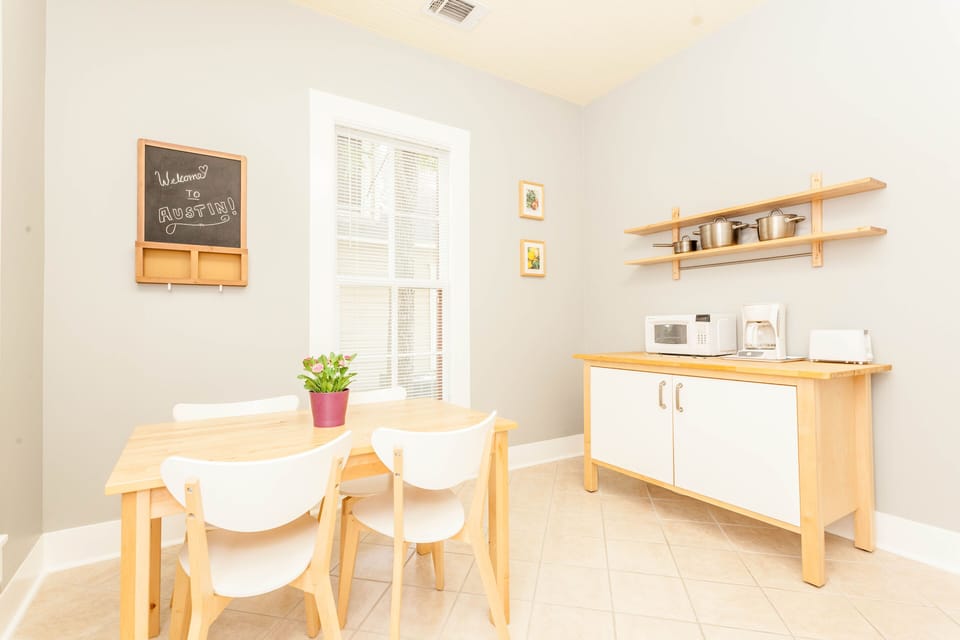 Kitchen with dining, pots, pans, plates