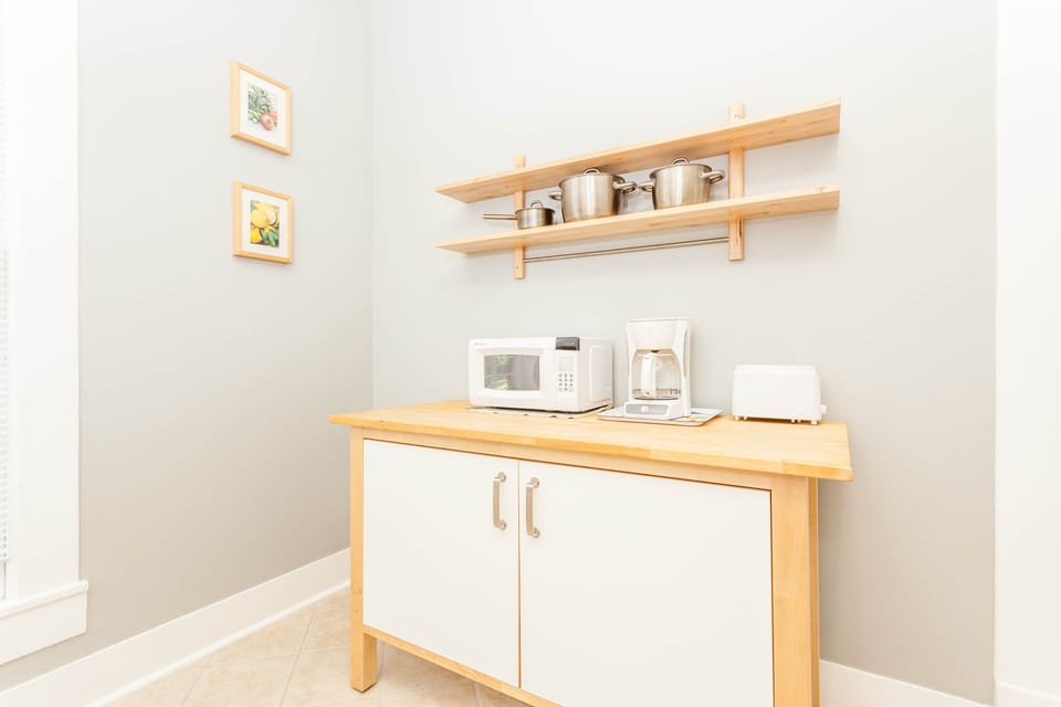 Kitchen with dining, pots, pans, plates