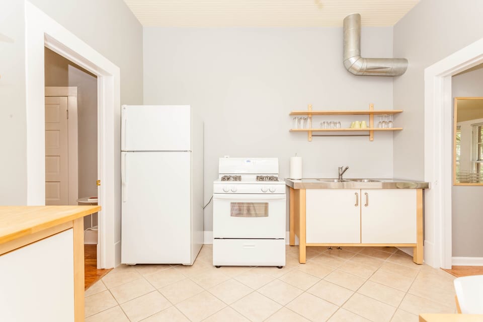 Kitchen with dining, pots, pans, plates