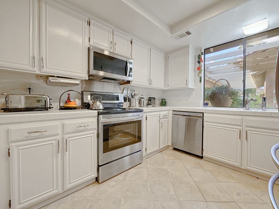 Kitchen with new stove, microwave and dishwasher.