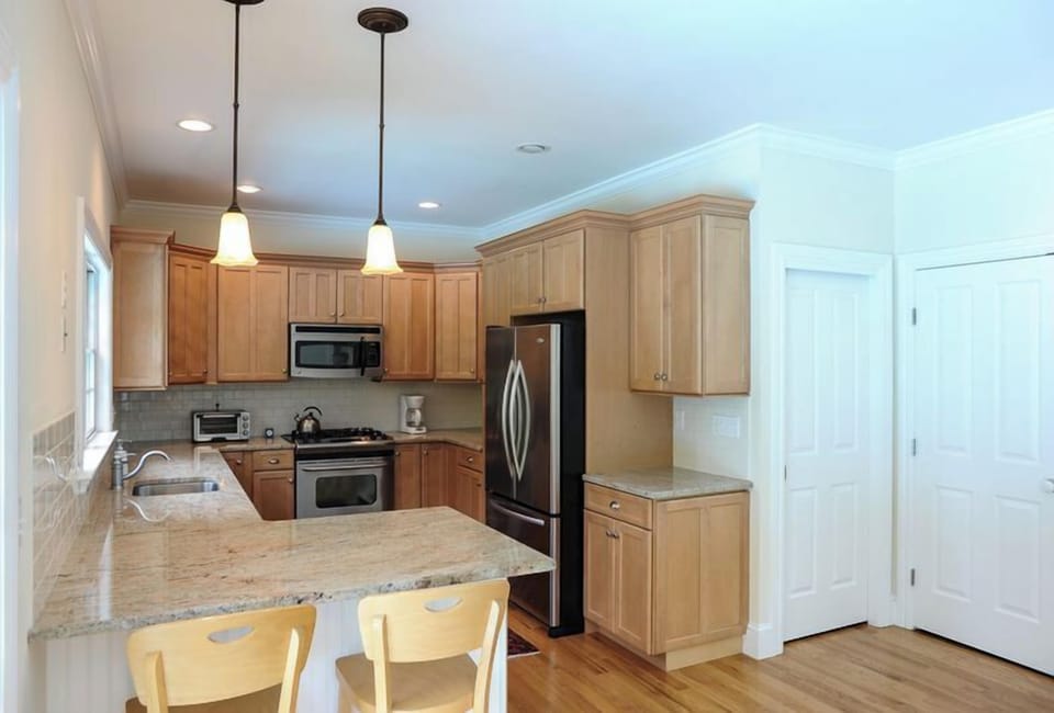 Chef's kitchen: gas range, granite, and stainless steel Energy Star appliances.