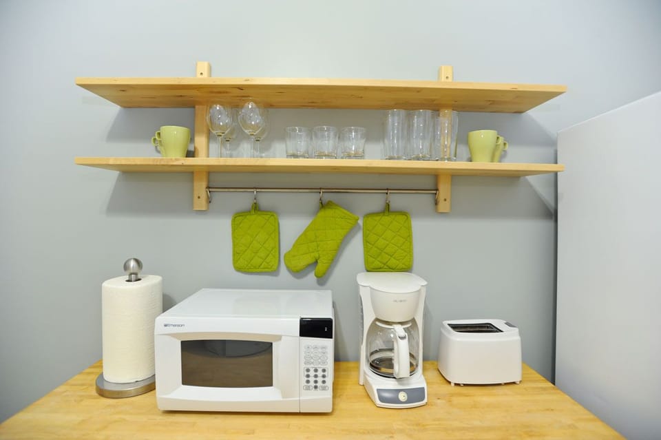 Kitchen with dining, pots, pans, plates