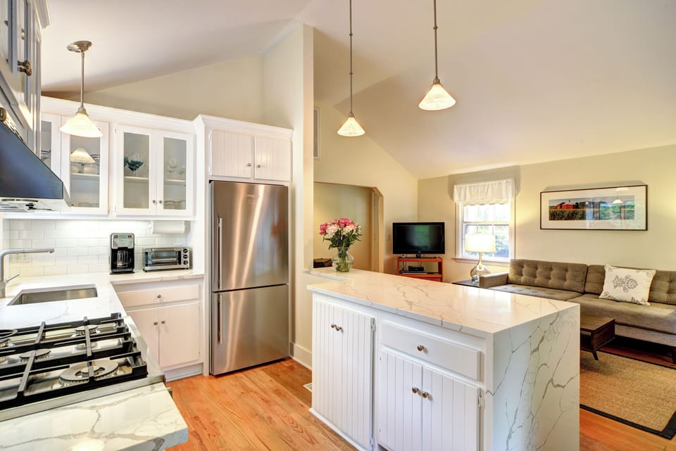 Stunning, new kitchen with quartz countertops, custom tile, and hardwood floor