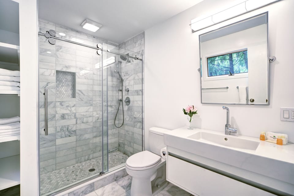 Modern private bath w/ marble tile, Duravit sink, Toto toilet, & Grohe fixtures.
