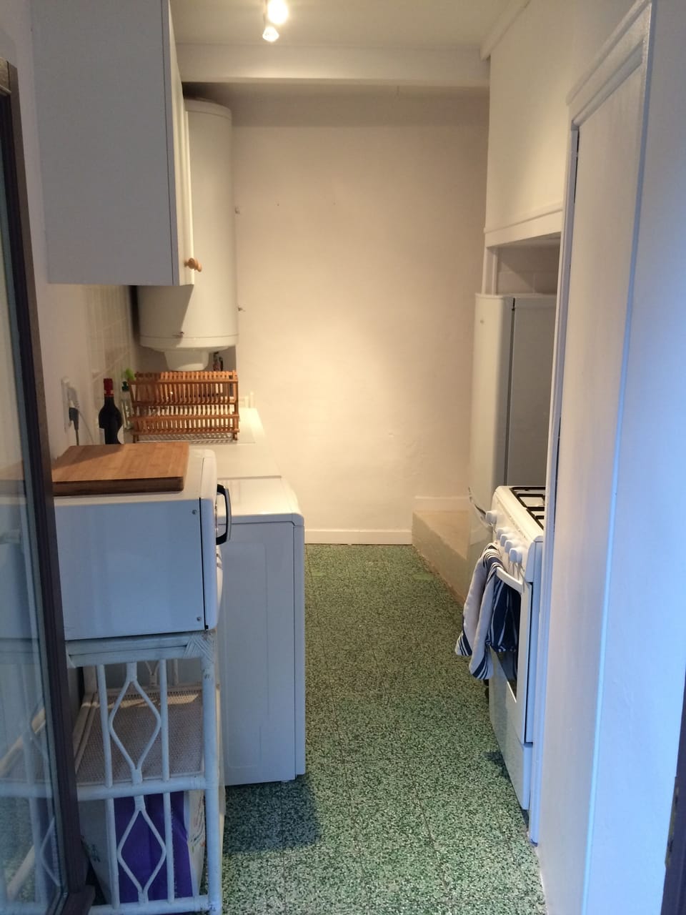 The galley kitchen with gas stove/oven, washing machine, fridge and microwave