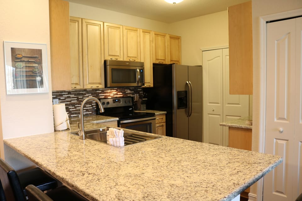 Newly fitted kitchen with solid maple wood cabinets and stone worktop