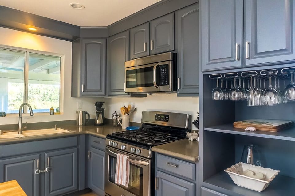 The kitchen is stocked with essentials and more, including spices and cookware.