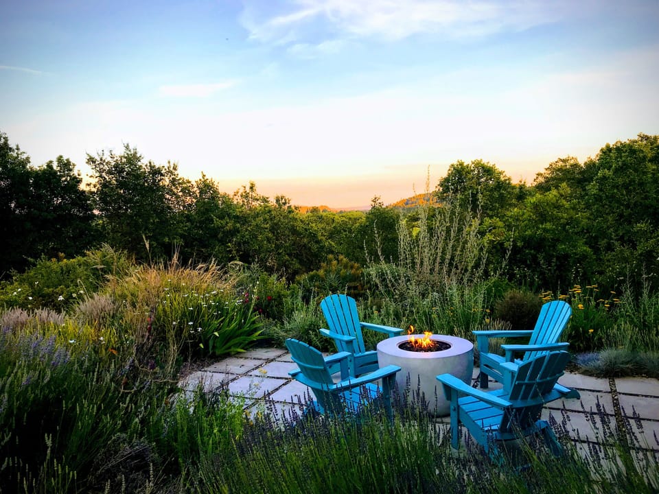 Watch the sunset immersed in the garden by the new fire pit. 