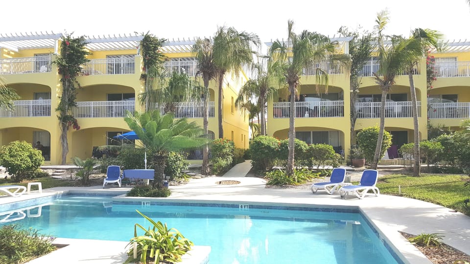 Pool, gardens, and apartment building.