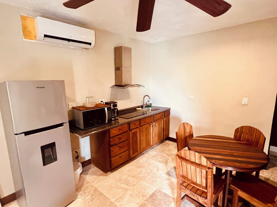 Fully equipped kitchenette with full-sized fridge, microwave, and dining area