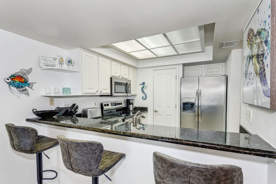 The beach is just minutes away with a lovely pool and the entire - Kitchen and bar