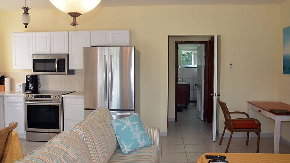 Kitchen. dining, and living areas configured for four, with new appliances