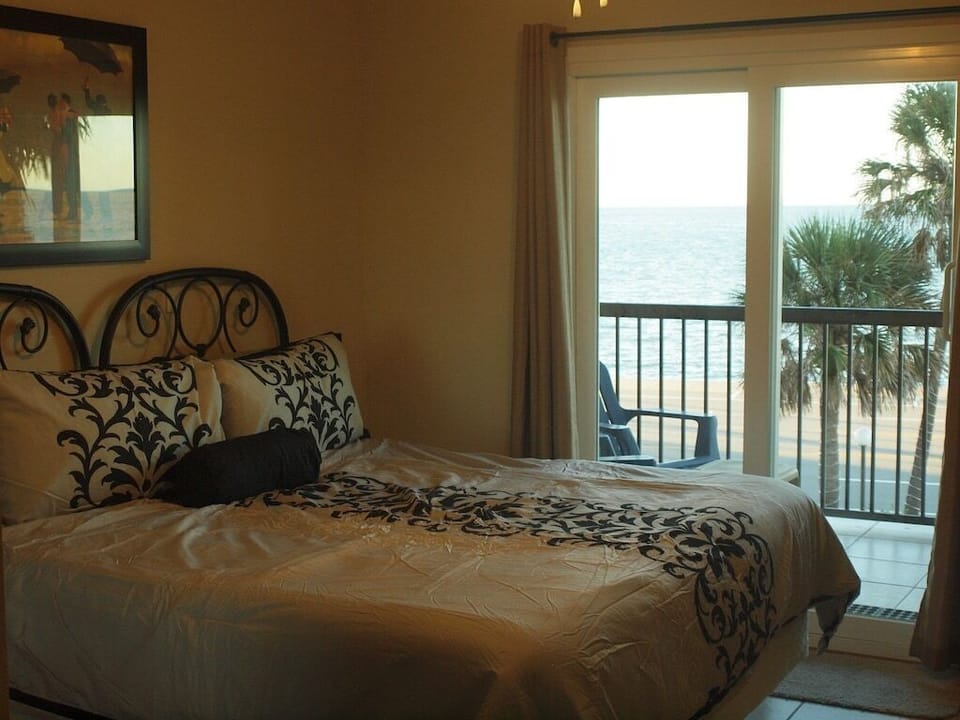 Master bedroom with sliding door access to the balcony
