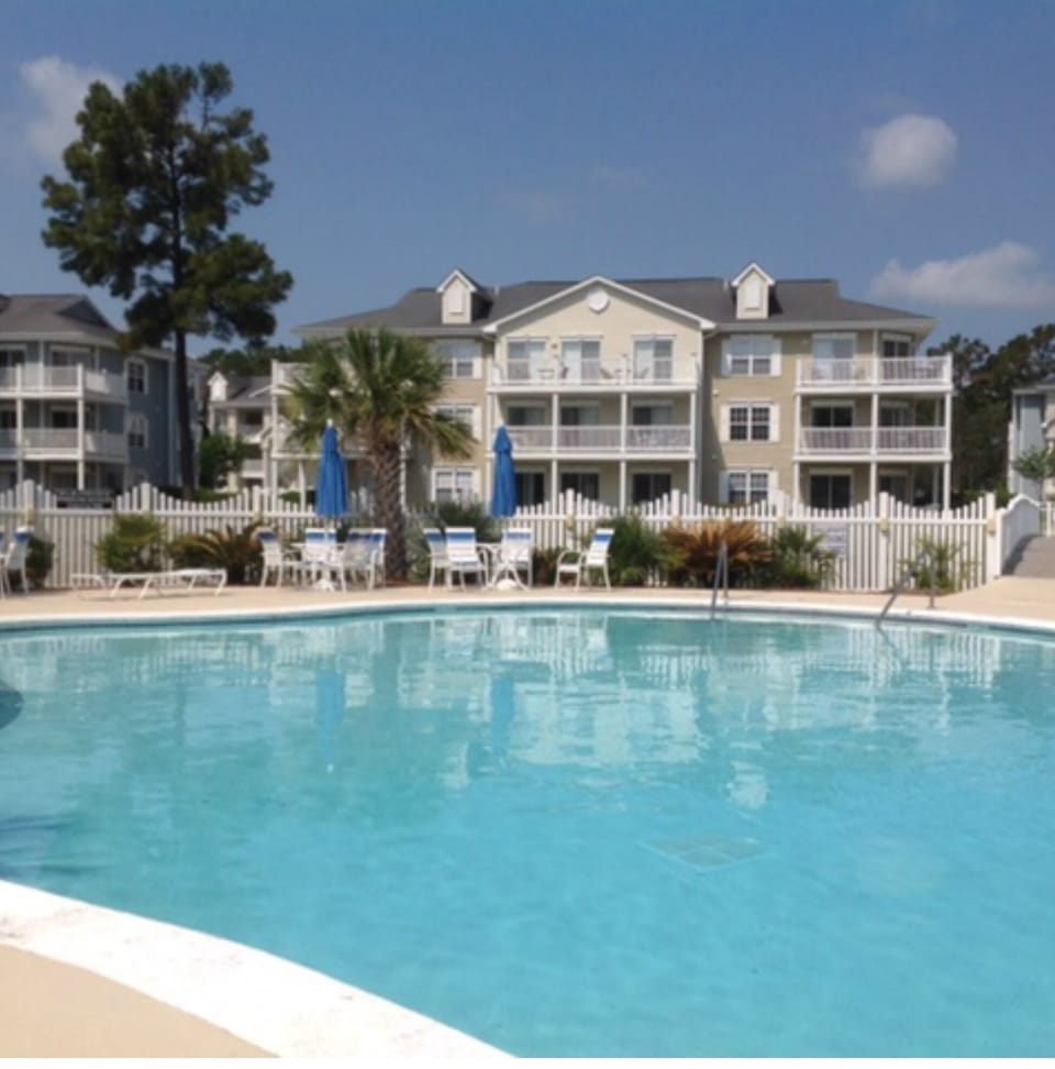 Beautiful pool with workout room and hottub  located across the parking lot .