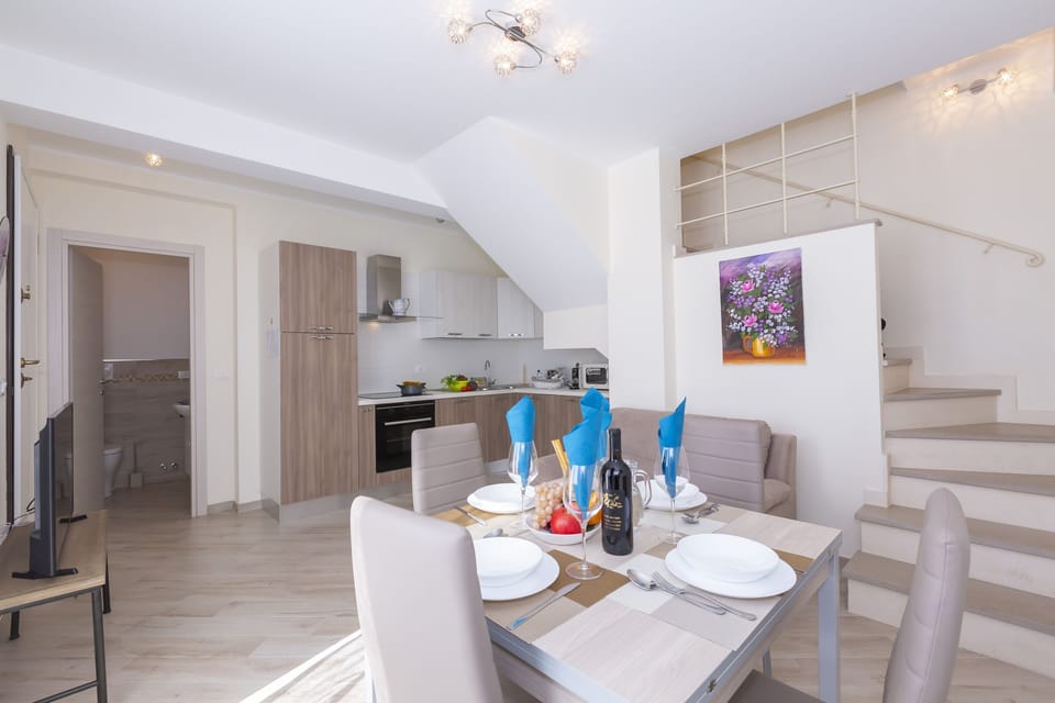 Living room with dining table and fully equipped kitchen