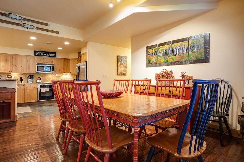 Gather around your spacious dining table where colorful chairs and warm wood create the perfect spot for memorable meals together.