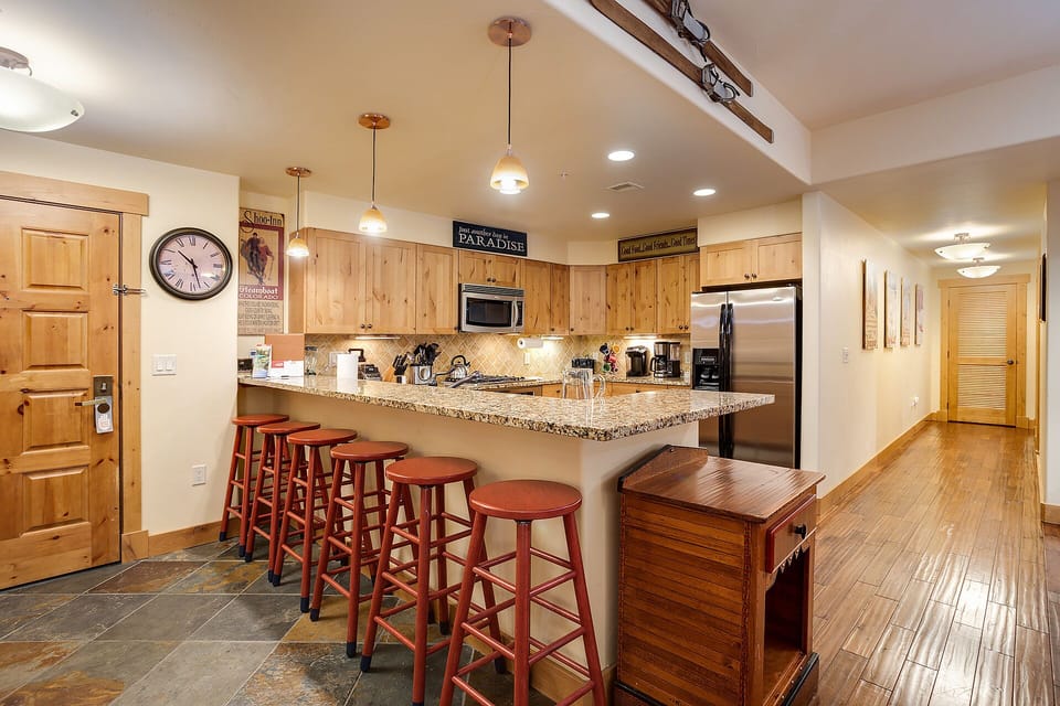 Gather around your spacious granite island where pendant lights cast a warm glow over your culinary adventures.