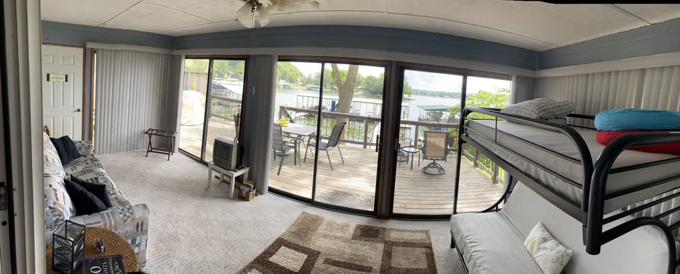 Bright, spacious sunroom with a small TV and children's DVDs.