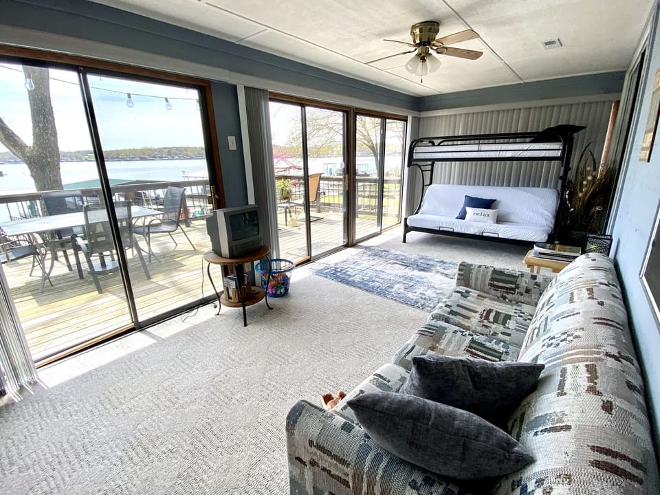 Sunroom with bunk beds and fold-out couch. Verticle blinds allow privacy.