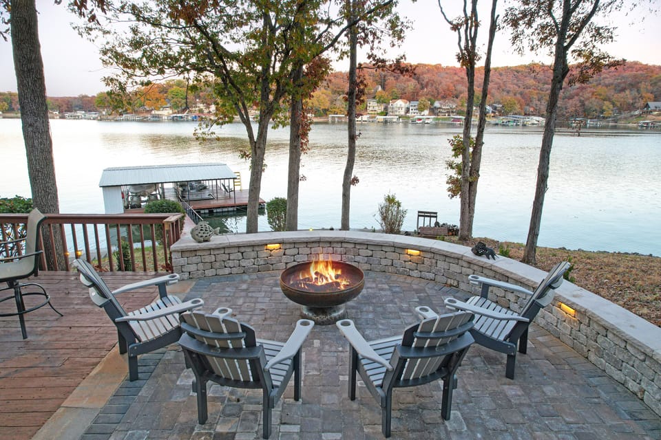 Viewing out into the cove from lower level stone patio. Mature trees w/ shade.