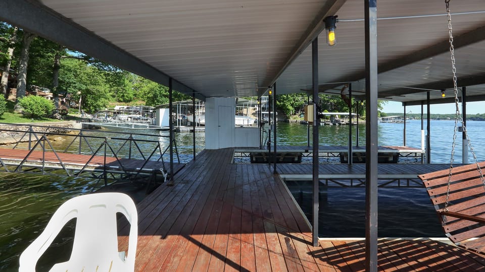 View of dock, dock storage shed, and dock boat slips from the dock swim deck.