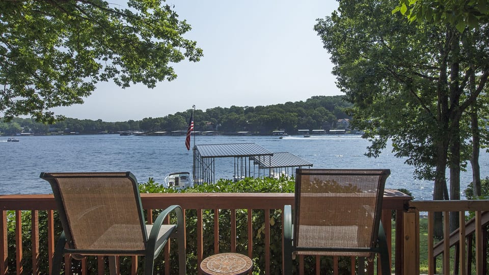 Viewing out into the cove from the large lower level deck. Mature trees w/ shade
