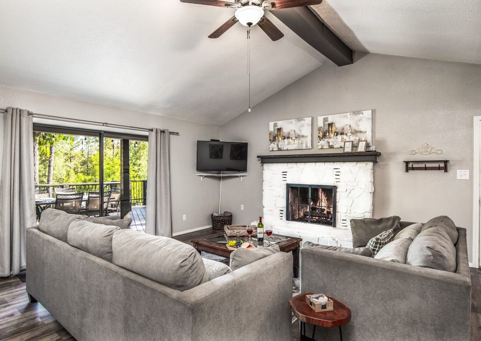 Living room with sliding door leading onto expansive back patio
