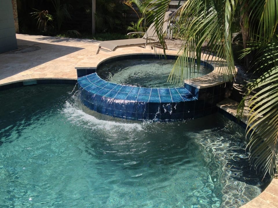 Spa with cascading water to pool, spa comfortably fits 6 (measures 6.5 ft rnd)