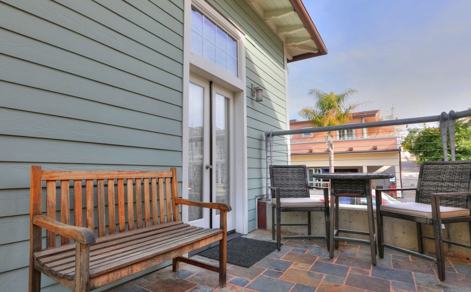 Private patio area with bistro table and bench seating. Webber Charcoal BBQ.