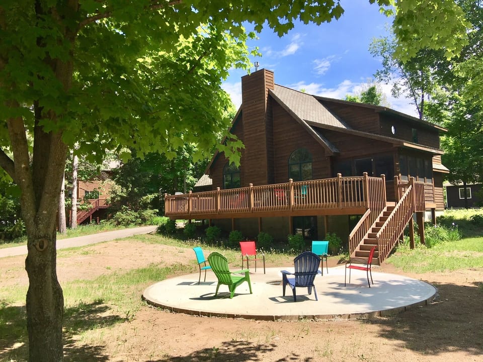 Front of house with large in-ground firepit.